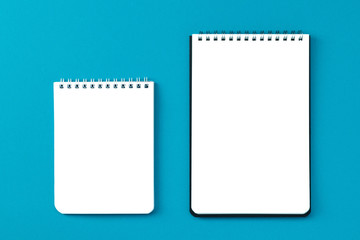 Copy space notebooks on a blue background top view.