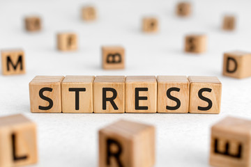 Stress - word from wooden blocks with letters, great worry caused by a difficult situation stress...