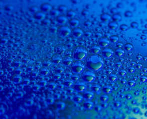 Lots of clean round water drops on blue background