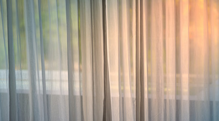 white thin see through curtains with sun light