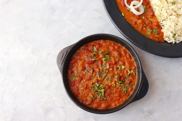 Rajma Chawal is a popular North Indian Food. Rajma is a socked Red kidney beans cooked with onions, tomatoes and a special blend of spices. Served with Jeera rice or Cumin Rice. With Copy Space.