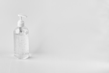 A white clear plastic bottle with transparent hand sanitizer gel isolated on a white background with copy space.