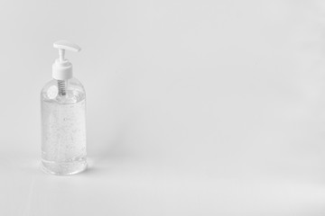 A white clear plastic bottle with transparent hand sanitizer gel isolated on a white background...