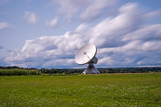 Huge parabolic antenna in the midst of a beautiful landscape