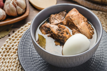Home Cooked Chicken Adobo (Close Up) is a Filipino dish stewed in vinegar, garlic, onion,  soy sauce, bay leaves, peppercorns  with some boiled egg on the side