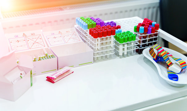 Tubes for analysis in the laboratory of hematology. Special equipment for laboratory. COVID-19 and coronavirus identification. Pandemic. Assistance in scrabs with medicine dropper.