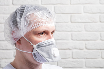 Medical mask, protection against coronavirus and other viruses on the white brick wall background