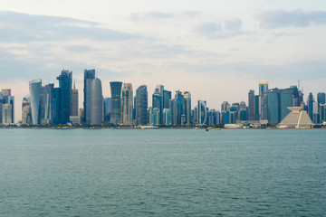 Fototapeta na wymiar View of modern skyscrapers and bay at twilight in Doha, Qatar