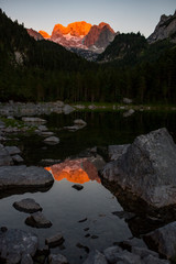 The Dachstein with a reflection at the Gosausee during sunset