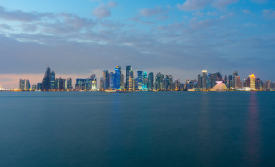 Fototapeta na wymiar View of modern skyscrapers and bay at twilight in Doha, Qatar