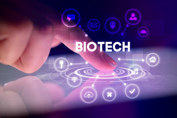 Finger touching tablet with web technology icons and BIOTECH inscription, web technology concept