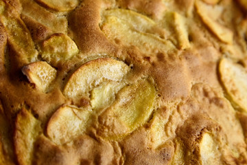 Apple pie, dessert from stewed fruits, closeup, texture, background. Charlotte, homemade baking