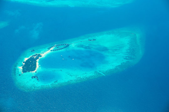 Aerial view from Waterplane of small Island at Maldives.