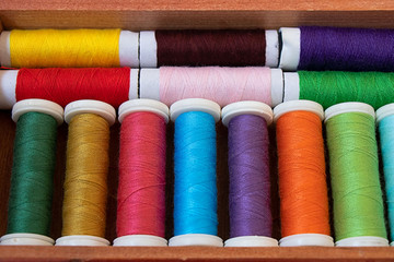 Fototapeta na wymiar Set of colored sewing strings in the box
