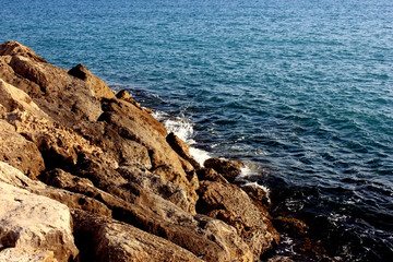 Rocky beach of the sea. Calm sunny weather. The sea is calm. There are no waves. Tourism. Cyprus ostrava coast. Bank is located on the Left. Copy space.