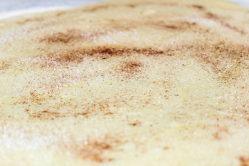 Rolled pastry sprinkled with sugar and cinnamon for baking buns.