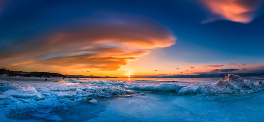 Obraz premium Sunset sky with natural breaking ice over frozen water on Lake Baikal, Siberia, Russia.