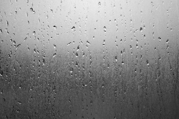 Water drops on the frosted glass texture background wallpaper, close up view