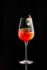 Drink in a glass with ice, mint and a slice of lemon. On a black background. Isolated.