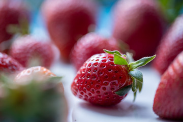 Fresh strawberries lying on the white table, spring time, macro shot