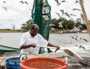 An African American man works on the deck of a commercial fishing vessel in South Carolina.