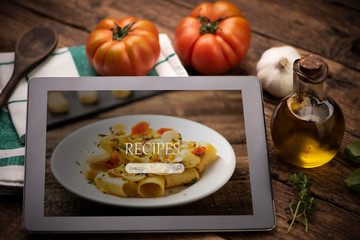 Food recipes tablet computer on rustic wooden table