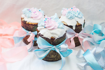 Traditional slavic orthodox easter cake named kulich with white icing, meringue decoration and festive ribbons