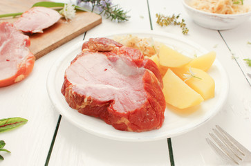 Kasseler Braten mit Salzkartoffeln und Sauerkraut Teller Gericht