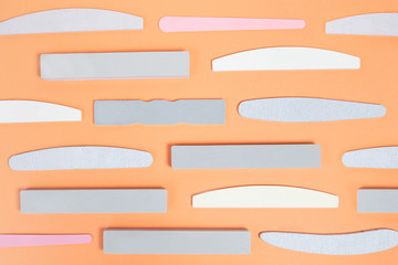 set of nail files for nails of different shapes and different stiffness on a beige background....