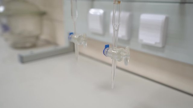 Medical research tubes equipment analysis scale water transparent laboratory empty flasks medical test closeup camera movement