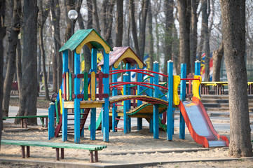 Fototapeta na wymiar Empty old bright wooden playground in the park. people are quarantined at home. abandoned city