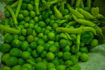 Stock Photo - green chili peppers and lemons