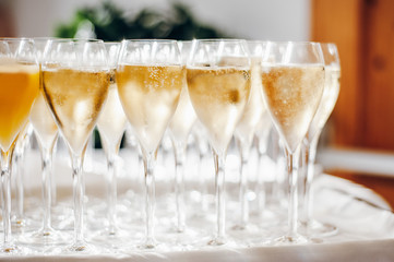 Glasses of champagne with bubbles on the table