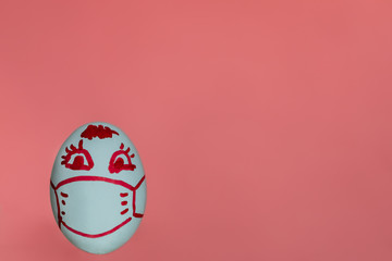 Easter egg in a medical mask on a pink background. Pandemic, coronavirus, quarantine, spring 2020. Flat lay, copy space. Food.