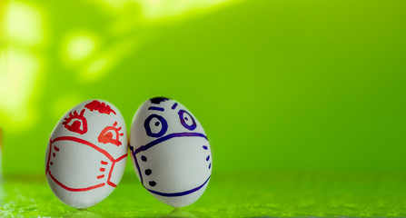 Two easter eggs on a green background. Creative. Pandemic, coronavirus, quarantine, spring 2020. Flat lay, copy space.