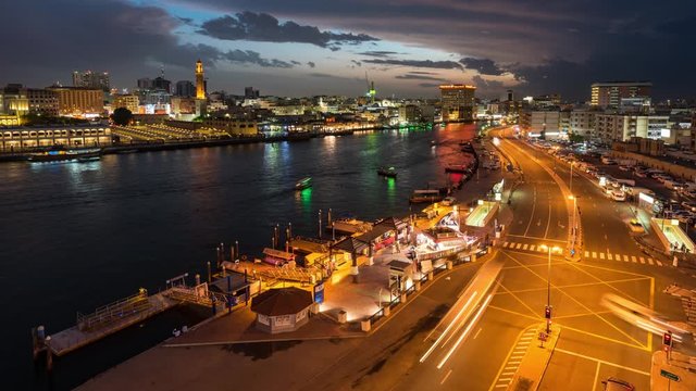 Night Timelapse of Old Dubai Creekside with Traditional Abras and Buildings.