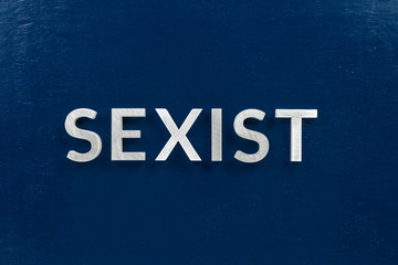 the word sexist laid with white letters on dark blue flat background