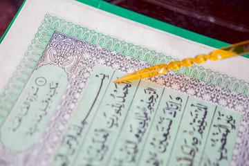 Quran with pointer in the mosque during ramadan