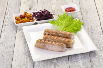 Grilled sausages served mushrooms and cabbage