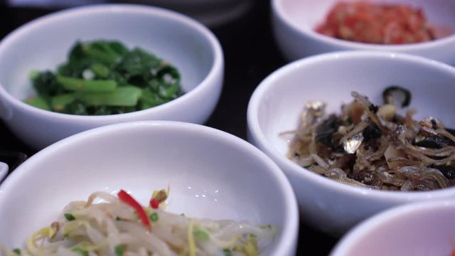 Variety of Korean small side dishes full table bbq meal