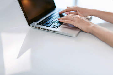 Young business woman is typing on laptop keyboard. Coronavirus. Quarantine. isolation, social distancing, freelance work from home office, self-isolation.