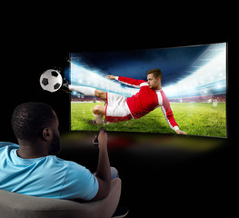 Viewer in front of a tv on the armchair at home feels inside the action