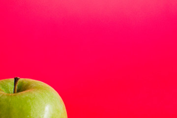 red apple on green background
