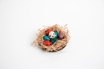 Multi-colored quail eggs for Easter in the filler