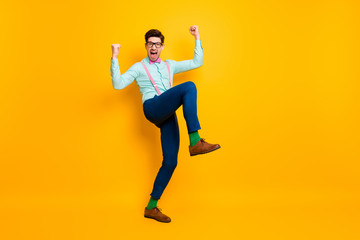 Fototapeta na wymiar Full body photo of handsome cool clothes guy celebrate quarantine finish rise fists ready chilling party wear specs shirt suspenders bow tie trousers shoes isolated yellow color background