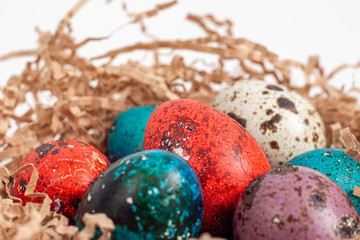 Multi-colored quail eggs for Easter in the filler