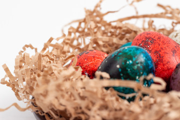 Multi-colored quail eggs for Easter in the filler