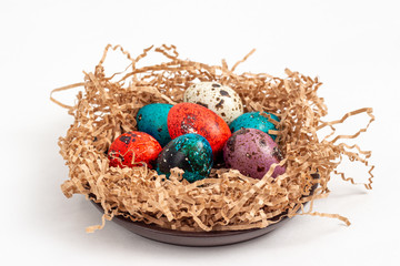 Multi-colored quail eggs for Easter in the filler