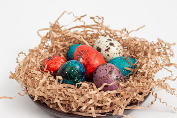 Fototapeta na wymiar Multi-colored quail eggs for Easter in the filler
