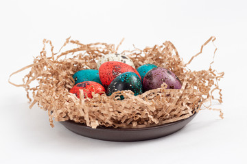 Multi-colored quail eggs for Easter in the filler